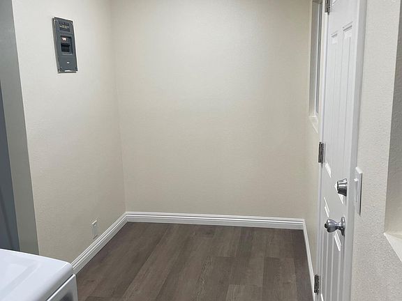 Laundry room, room for additional storage on this wall.