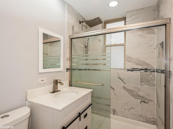Modern bath with rain head shower and body spray