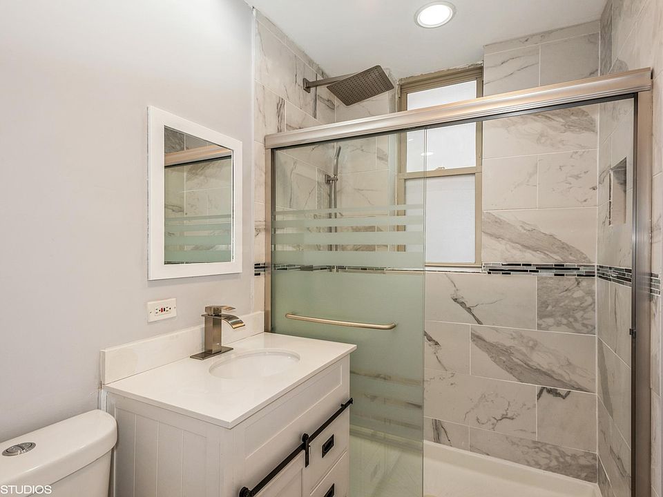 Modern bath with rain head shower and body spray