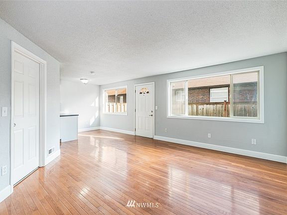 Functional layout with living room, access to stairs, storage, laundry room, and kitchen