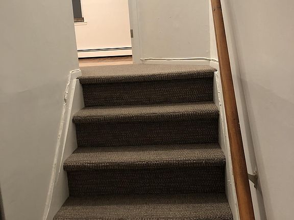 Stairs leading to second floor duplex bedroom and bathroom