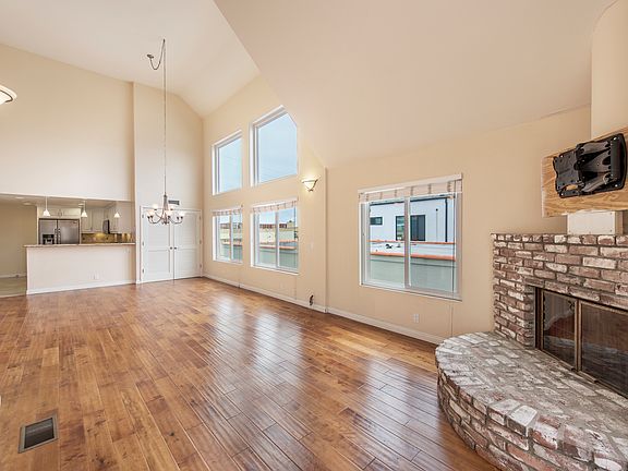 Bright and spacious with huge wall of windows, hardwood floors, balcony and soaring ceilings