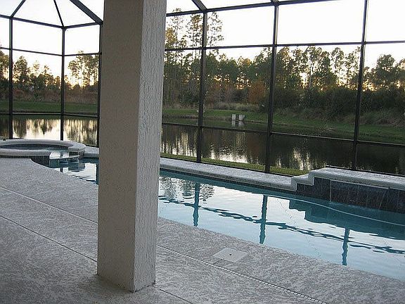 View of pool, waterfront and nature preserve.