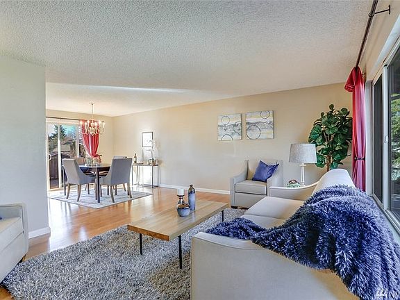 The living room boasts over-sized windows and views into the dining room.