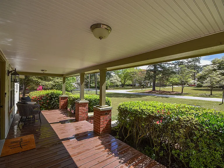 Covered porch overlooking the large front yard