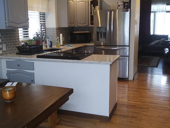 Large kitchen with stainless steel appliances and built-in wine refrigerator
