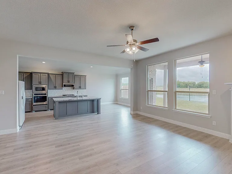 The sunlit living room flows seamlessly into the kitchen and breakfast area making family time plentiful and bearable at the same time