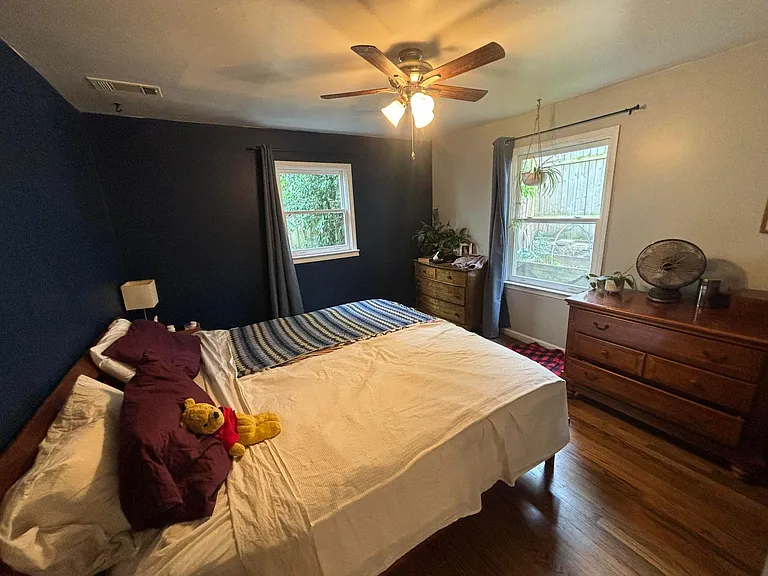 Bedroom 3 in the back of house. This a large bedroom across from larger full bathroom and laundry room. It has 2 large windows.