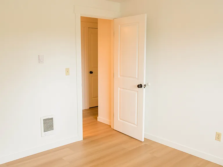 Bright room with freshly repainted walls, updated flooring, and a clean modern feel. Flexible space for a bedroom, office, or guest room.