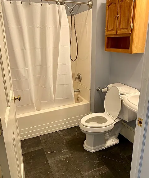 Bathroom has tub and shower.