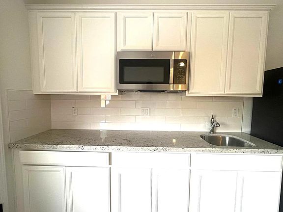 Kitchenette with a microwave. Counter-top stove will be added.