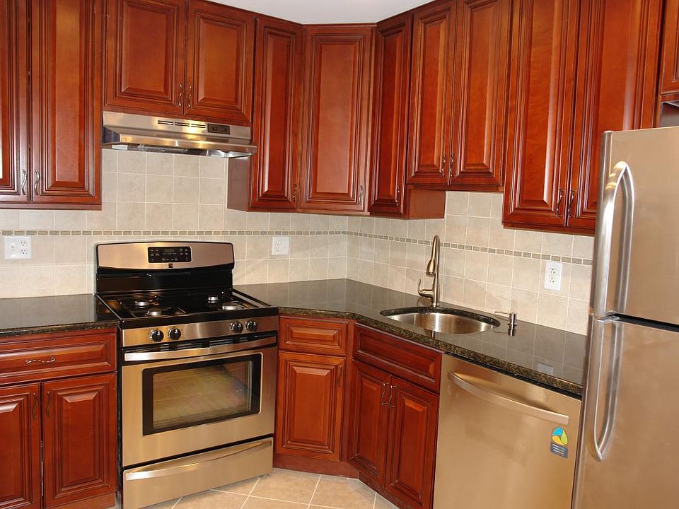 Kitchen has stainless still appliances, granite countertop,