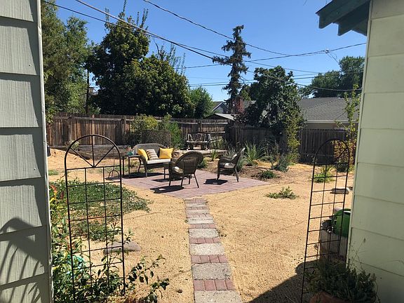 Landscaped Backyard with Raised Planter Bed for Garden