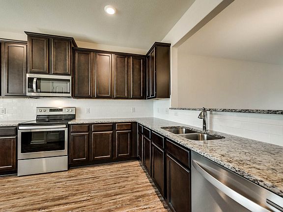The kitchen comes with a full suite of stainless-steel appliances.