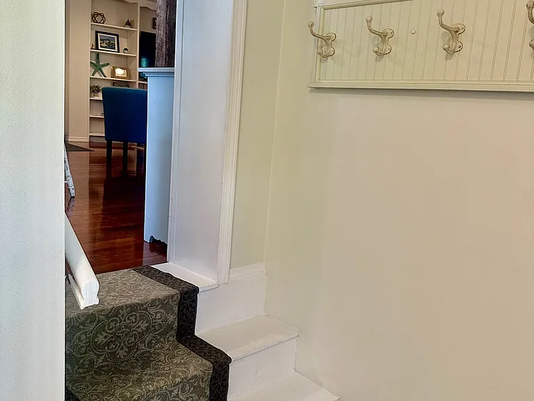 Stairway into cottage living from the mudroom entrance.