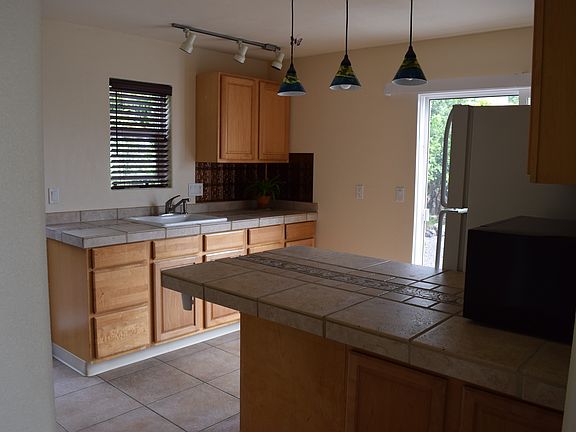 Kitchen with full size refrigerator and sink (no full stove)