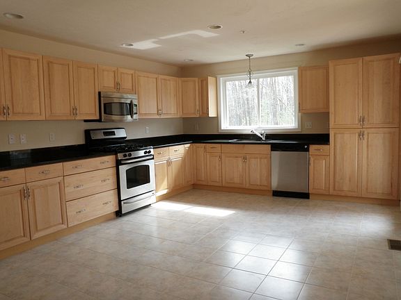 Kitchen with tiled floors and granite counters