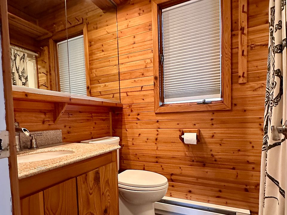 Cedar walls, slate tile, large wall mirror/cabinet.