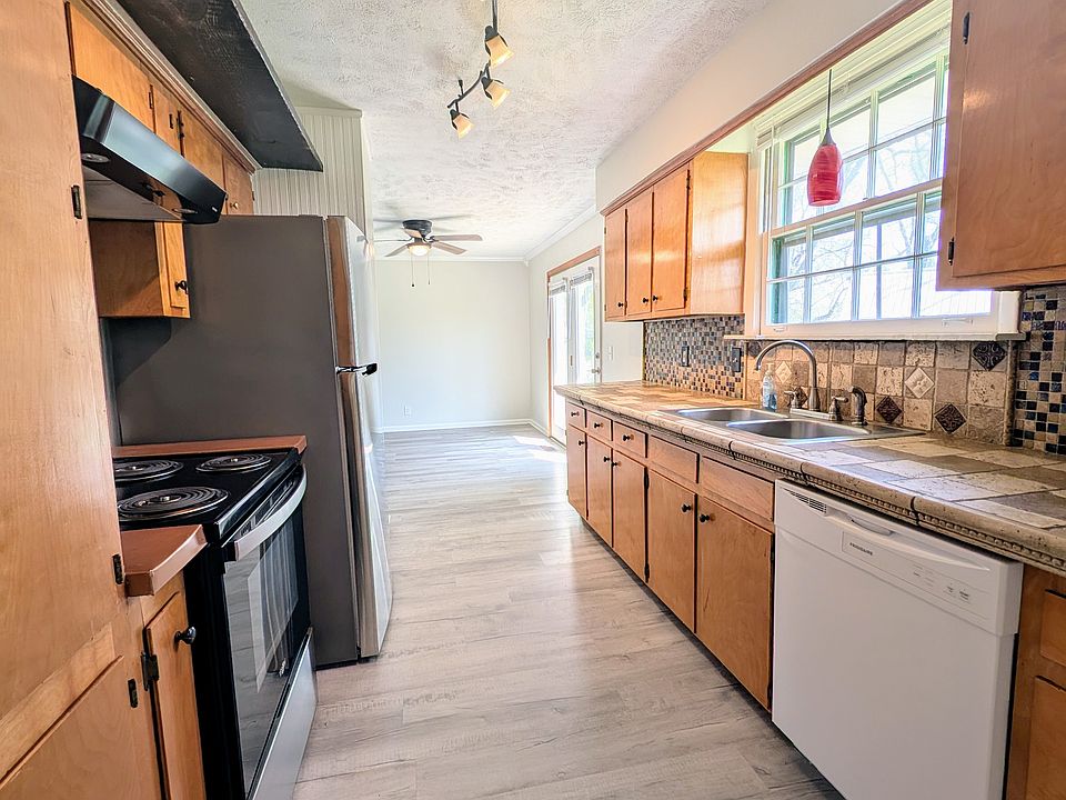 Full view of the kitchen facing the dining room and sliding doors to the back yard.