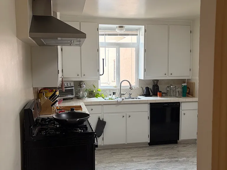 Dining room into kitchen, has lovely skylight