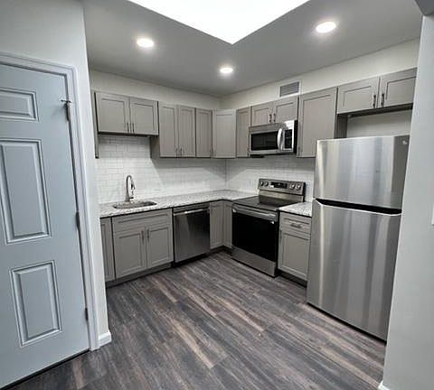 Kitchen (with skylight!). Brand new appliances (refrigerator, stove, dishwasher, and microwave), cabinets and countertop.