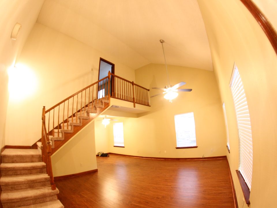 Living room with laminate floors and cathedral ceiling