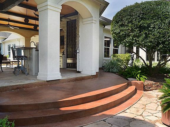 The back of the Texas sized Cabana is witnessed here. It is evocative of an old-world elegance and grace that is all too hard to find these days. Beamed ceilings, massive columns, steps, and patio bring to mind a splendor both modern and romantic.