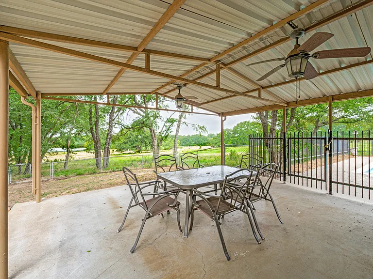 Covered patio with gated access to the pool and full bath just inside the patio door.