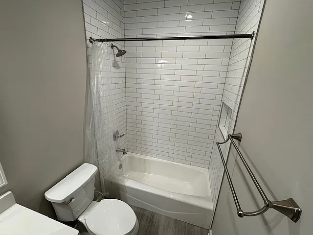 Main level hall bathroom cast iron bathtub with ceramic tile to the ceiling