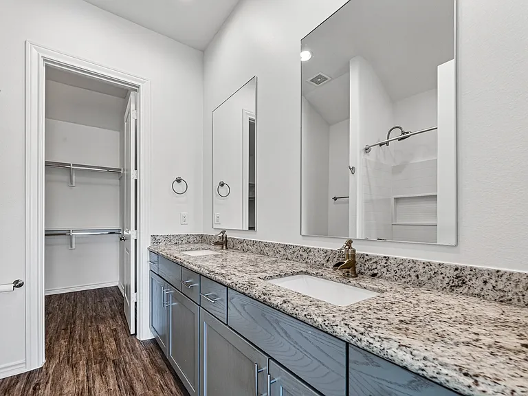 Primary suite features a private ensuite bathroom with a tub and shower combination.