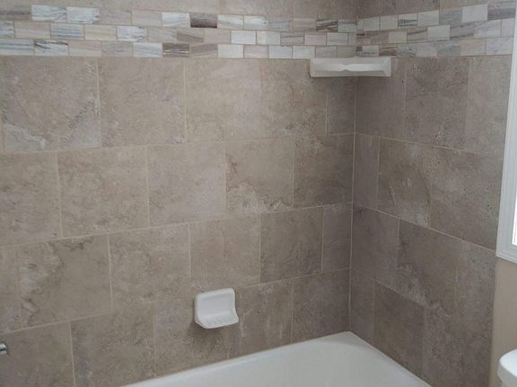 Brand new bathroom - close up of the beautiful new tub and tile tub surround!