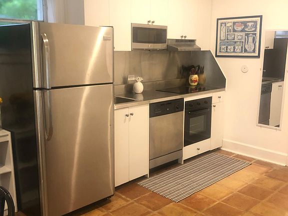 Kitchen with full Refrigerator, dishwasher, micorwarve and oven stainless steel counter top
