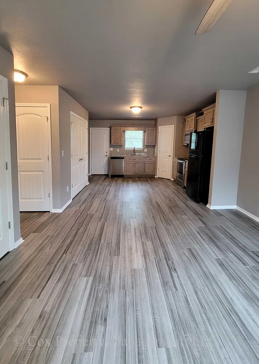 Open floor plan, living and kitchen area

Photos represent colors and finishes but are not of the specific unit listed. - 10940 Danny Bryan Rd #F-2
