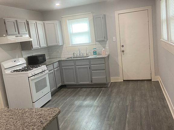 KITCHEN SHOWING PARTIAL GRANITE COUNTERTOP & NEW FLOORING