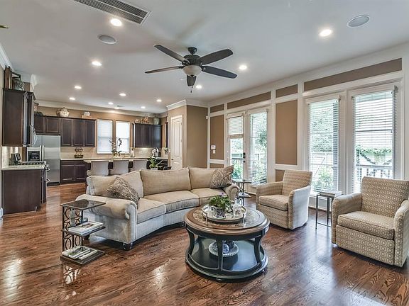 The spacious living area boast double crown molding, blinds on all window, neutral paint with lovely views of the back porch and backyard.
