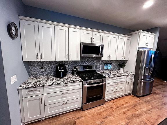 Kitchen with stainless appliances and granite counters on the breakfast bar