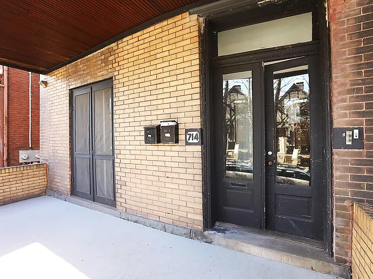 French doors on left open from living room, the porch from mailboxes to the left is outdoor space dedicated to this apartment