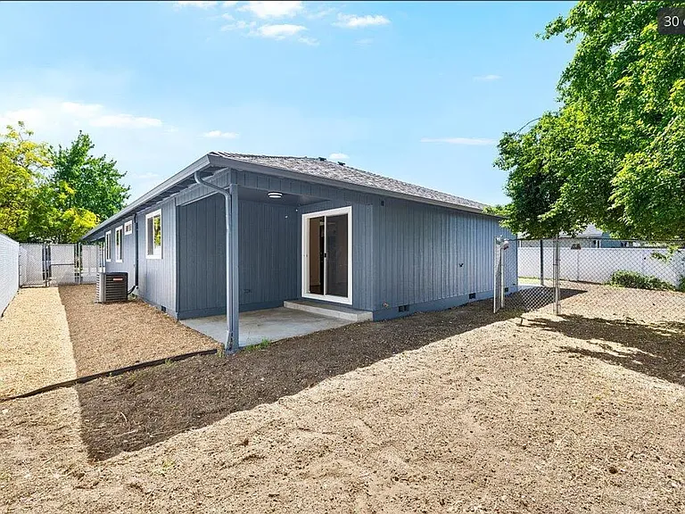 Fully fenced backyard with covered patio