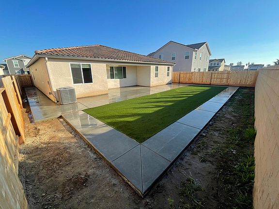 Backyard with concrete and grass!