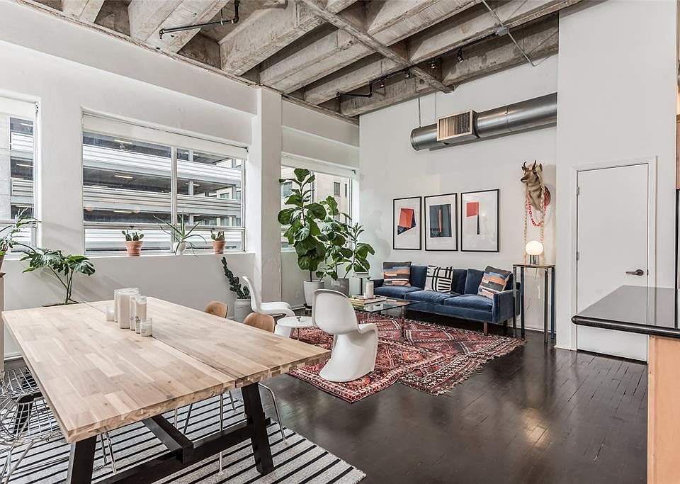 Wall of windows facing over Fannin St. flood the entertaining areas with natural light. Solar shade window coverings on all windows almost disappear when raised. Reclaimed hardwood floors are dark stained creating a contrast to the white walls and gr