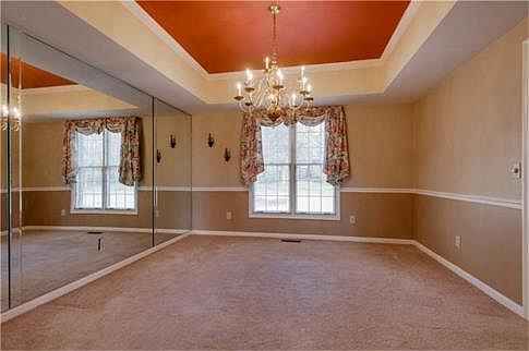 Formal Dining Room has Trey ceiling and chandelier with chair rail.