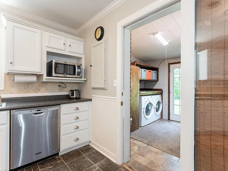 Kitchen opens to office/laundry area.