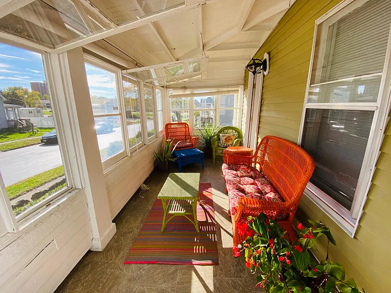 Sunporch windows and screens open and closed to protect against the elements.