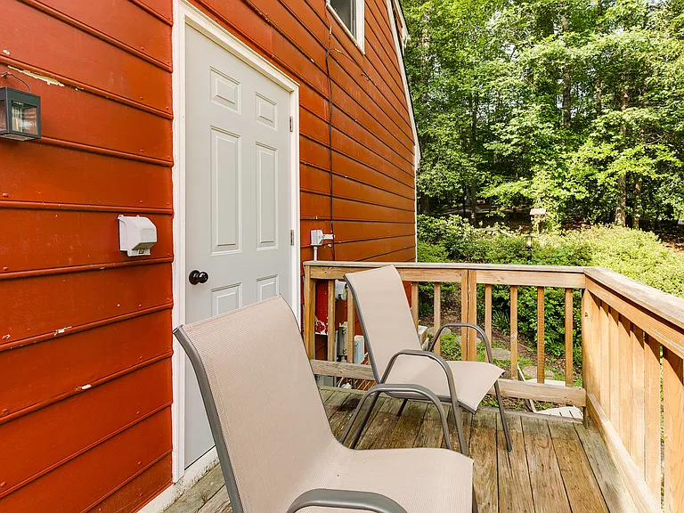 Side porch with attached storage closet.