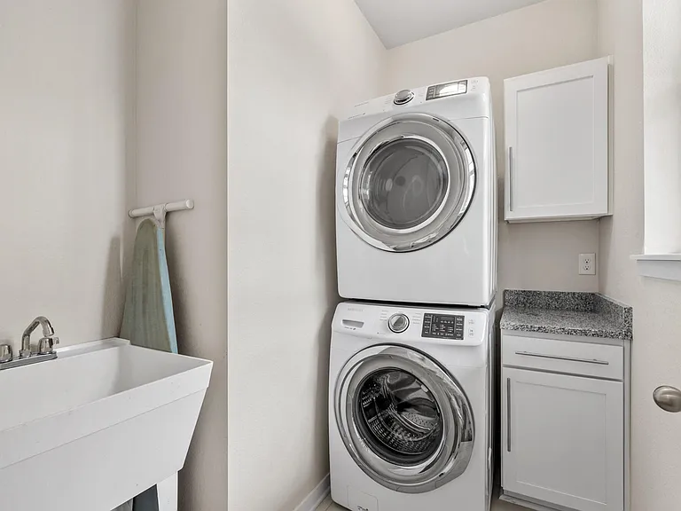 Washer and dryer, along with utility sink, stay with the property.