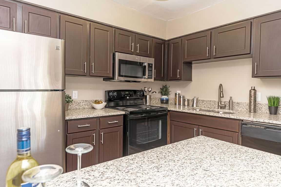 Kitchen with granite counters, stainless appliances, and modern cabinetry