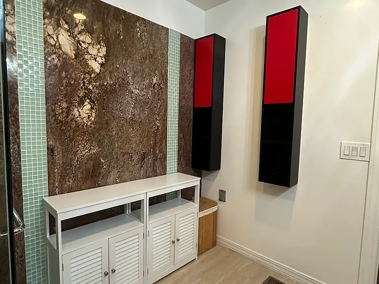 Generously sized bathroom with convenient shelving and storage space.