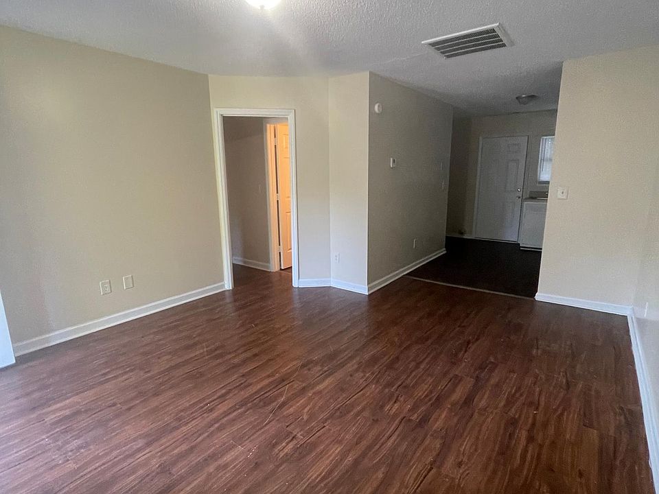 Living room looking into kitchen/hallway