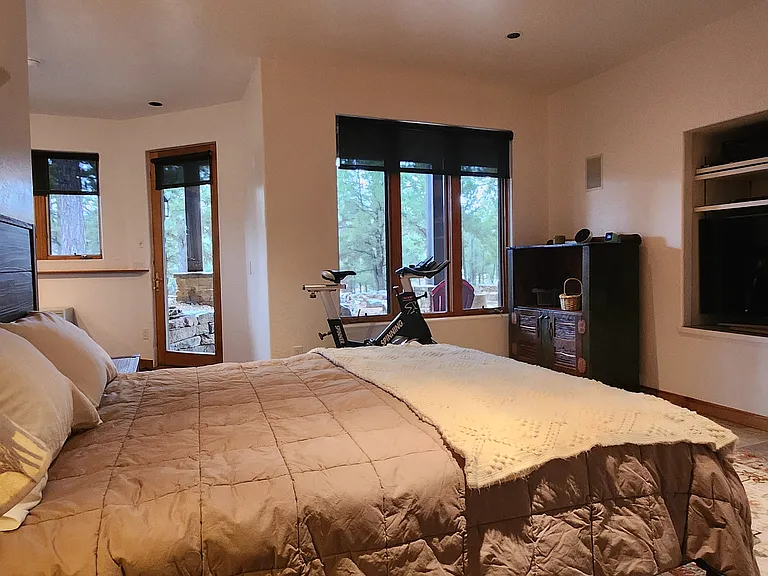Large downstairs bedroom with view to patio