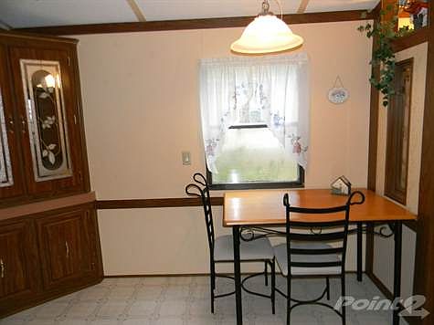 Dining area has built-in cabinetry for extra storage.